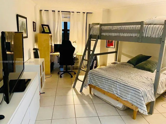 a bedroom with furniture and a window