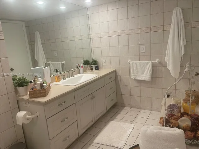 a bathroom with a sink mirror and shower