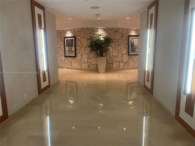 a view of a hallway with seating area