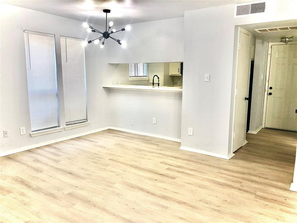 9601 Walnut Street, Unit 5101 Dallas, TX 75243 - Photo 4 of 11 a view of a kitchen with wooden cabinet and a ceiling fan