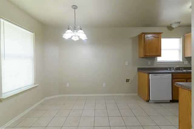 a kitchen with kitchen island granite countertop stove top oven and cabinets