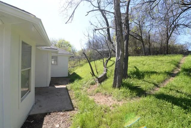 a backyard of a house with lots of green space
