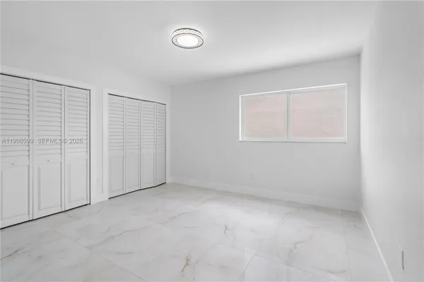 an empty room with a empty space and windows