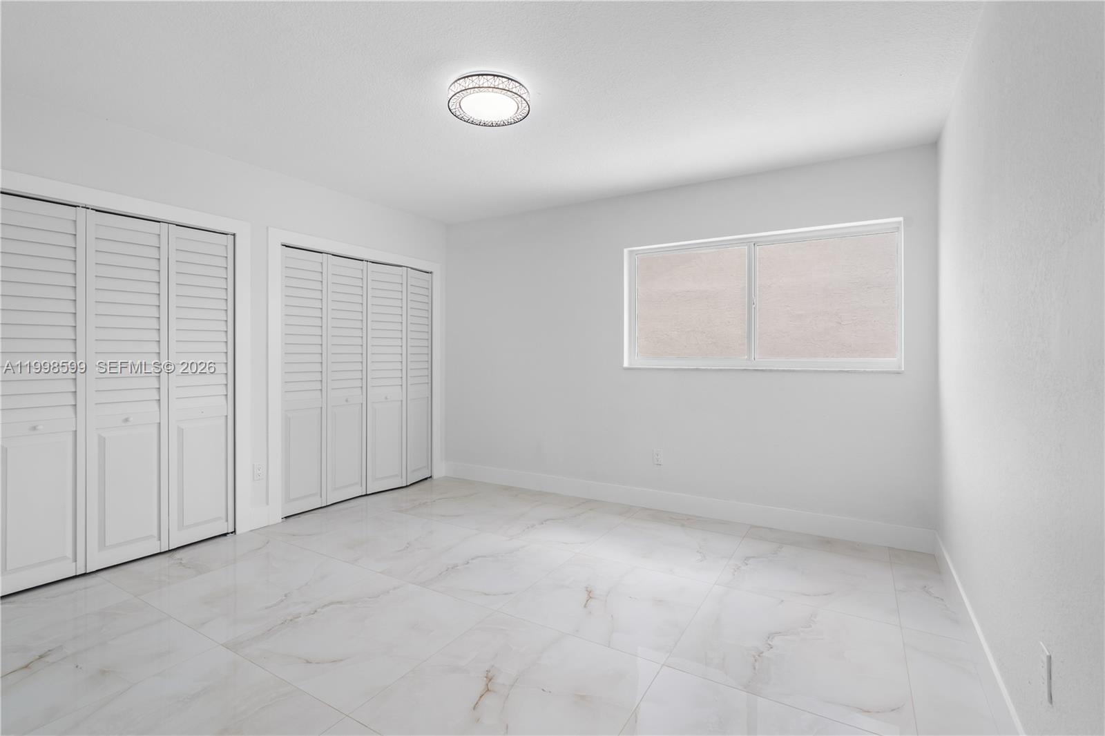 16345 Southwest 303rd Street Homestead, FL 33033 - Photo 13 of 19 an empty room with a empty space and windows