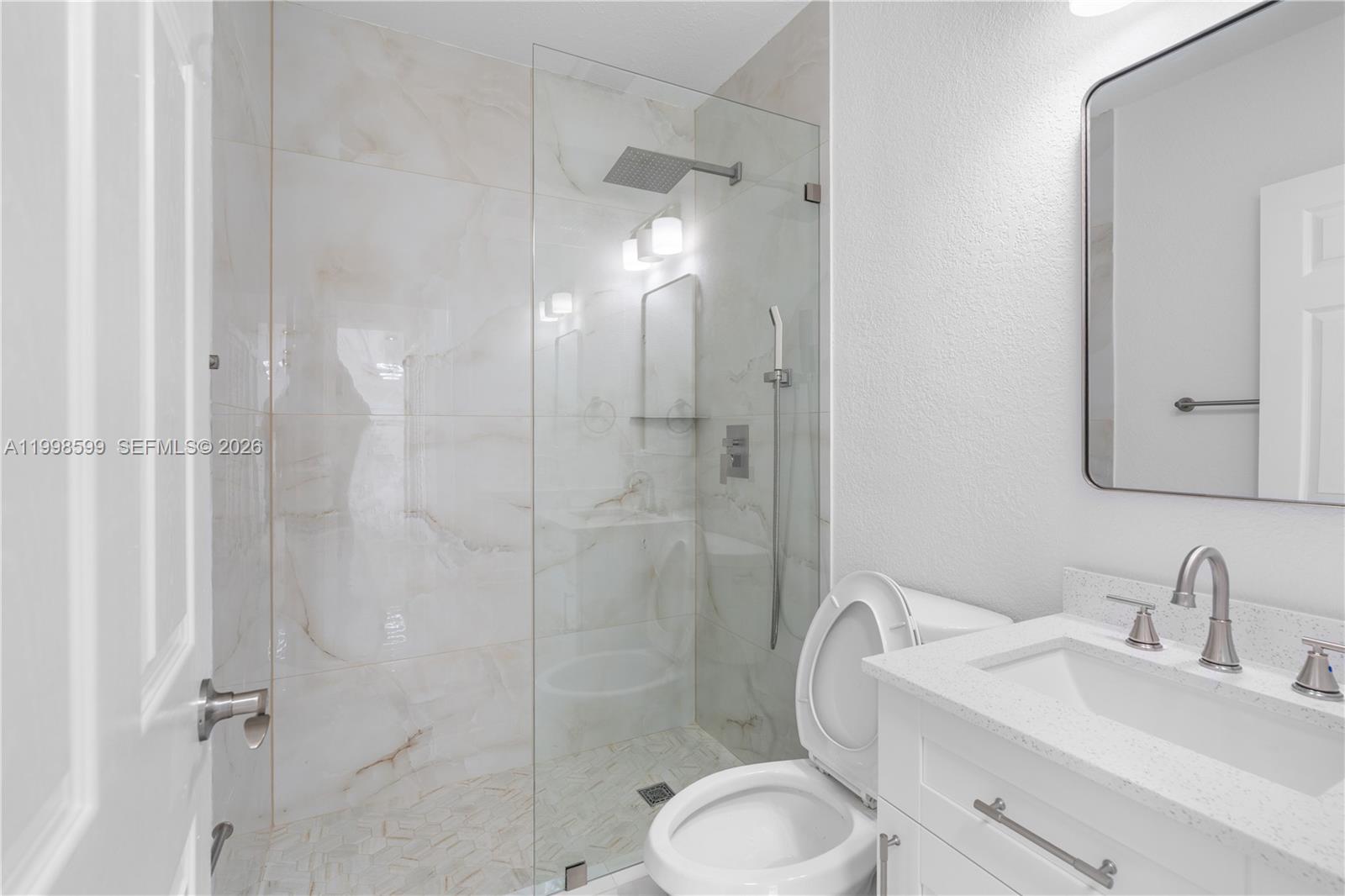 16345 Southwest 303rd Street Homestead, FL 33033 - Photo 14 of 19 a bathroom with a granite countertop sink toilet and shower