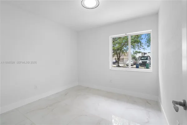 a view of an empty room with a window
