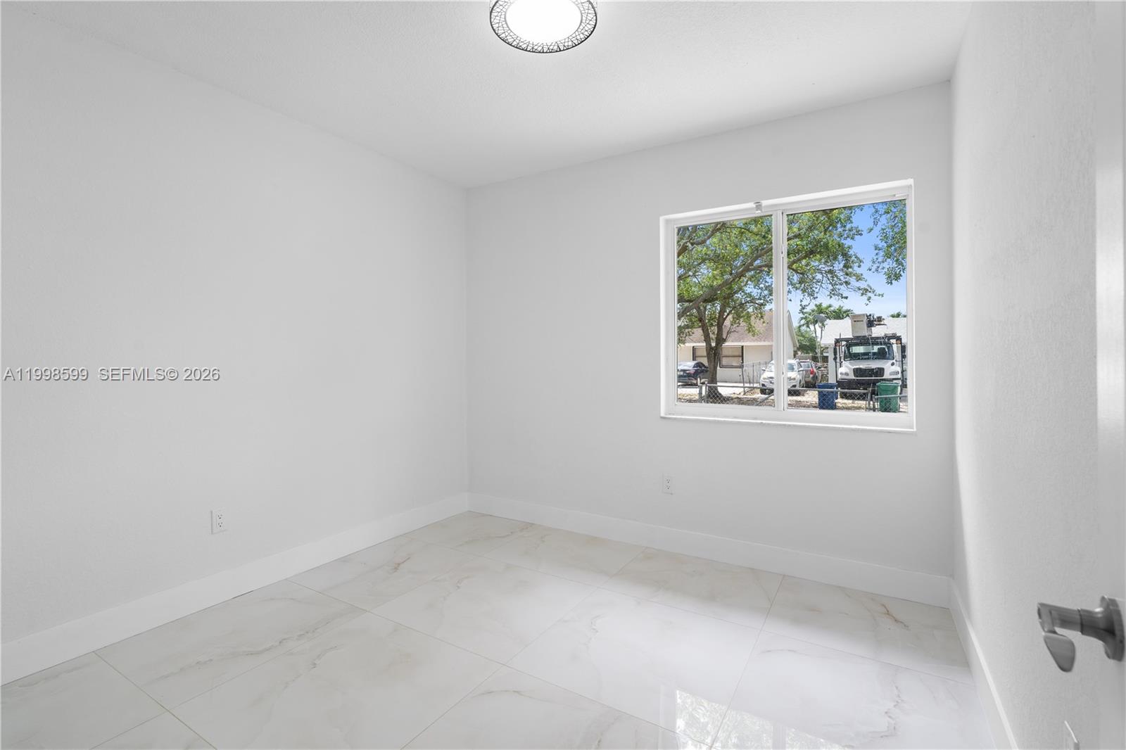 16345 Southwest 303rd Street Homestead, FL 33033 - Photo 17 of 19 a view of an empty room with a window
