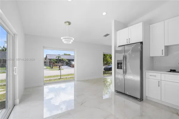 a kitchen with stainless steel appliances a refrigerator and a stove top oven