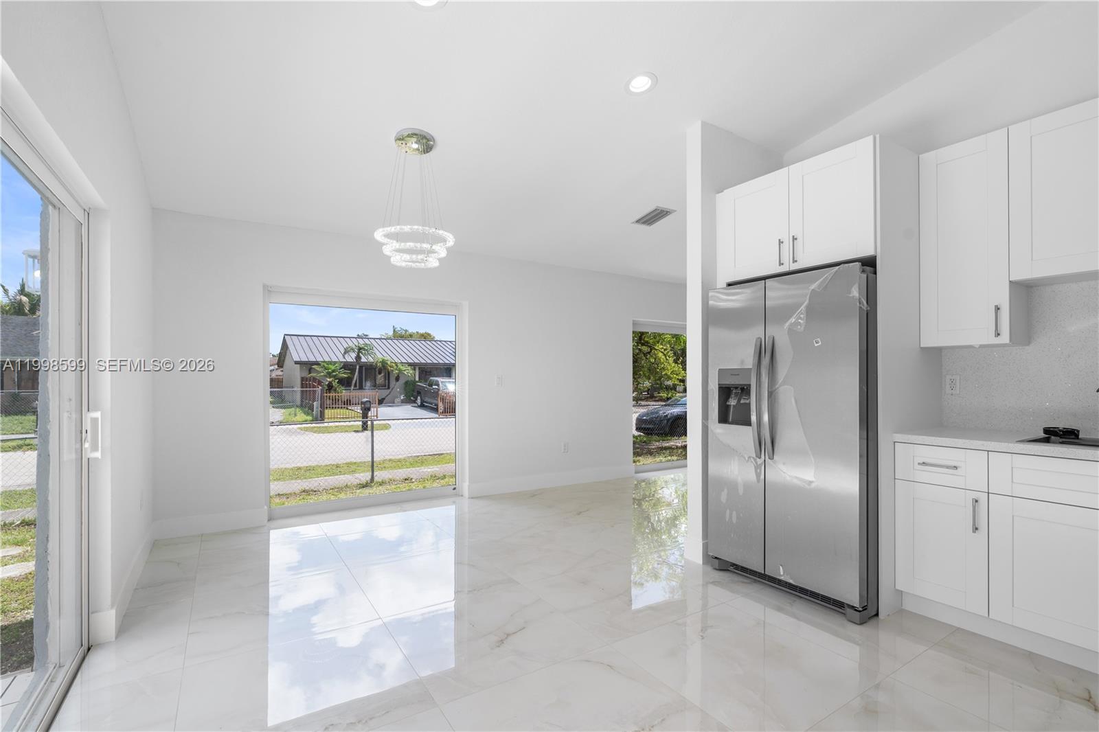 16345 Southwest 303rd Street Homestead, FL 33033 - Photo 5 of 19 a kitchen with stainless steel appliances a refrigerator and a stove top oven