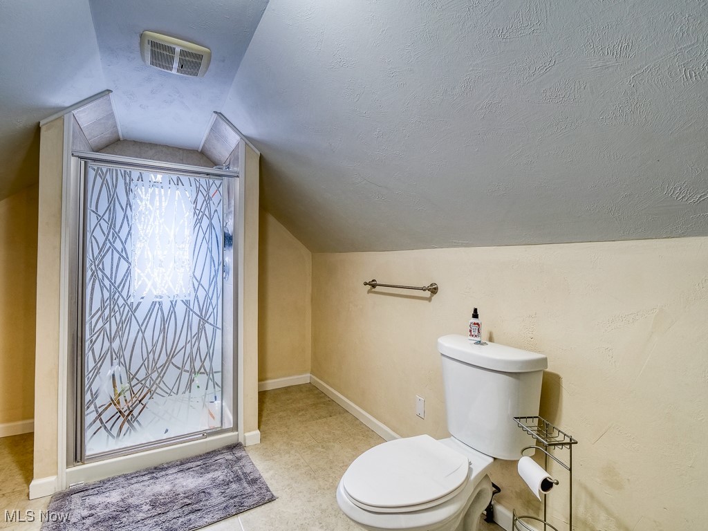 6794 York Road Cleveland, OH 44130 - Photo 32 of 45 Full bath featuring a stall shower, a textured ceiling, and lofted ceiling