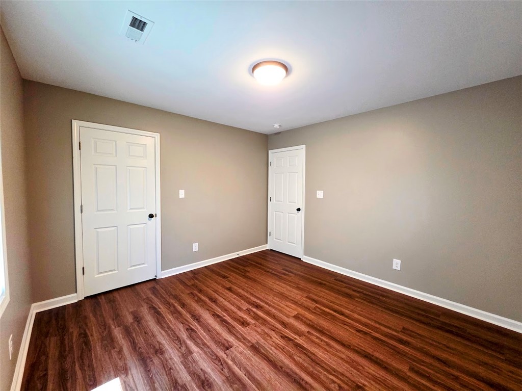 509 Elrod Road Piedmont, SC 29673 - Photo 20 of 28 Rich hardwood-style flooring extends across this neutrally painted bedroom, ready for personalization.