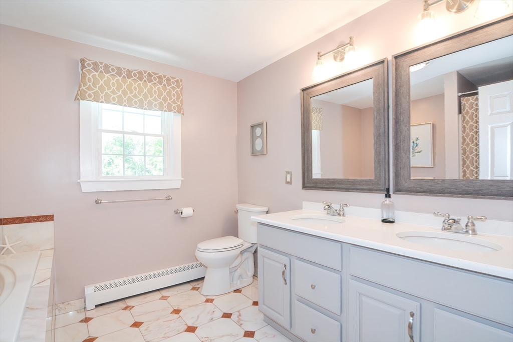 13 Park Street Mendon, MA 01756 - Photo 28 of 37 a bathroom with a sink a toilet and a mirror