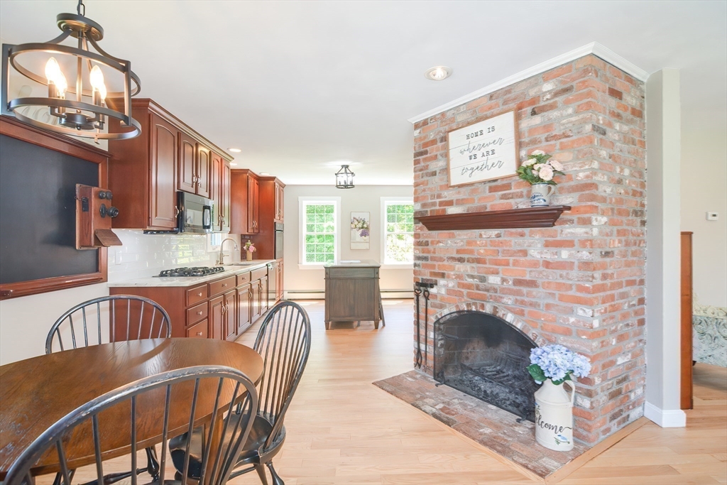 13 Park Street Mendon, MA 01756 - Photo 10 of 37 a living room with furniture a flat screen tv and a fireplace
