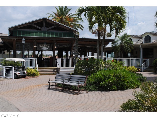 2060 Matecumbe Key Road Punta Gorda, FL 33955 - Photo 15 of 16 a backyard of a house with barbeque oven table and chairs