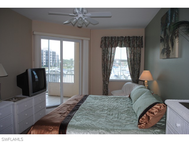 2060 Matecumbe Key Road Punta Gorda, FL 33955 - Photo 7 of 16 a bedroom with a bed and large windows
