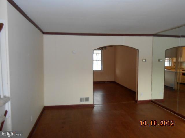 7444 Durwood Road Baltimore, MD 21222 - Photo 3 of 11 a view of empty room with wooden floor