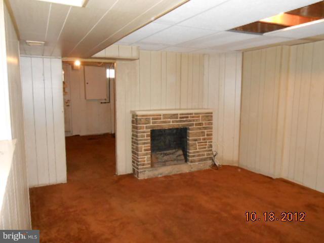 7444 Durwood Road Baltimore, MD 21222 - Photo 5 of 11 a view of an empty room with a fireplace