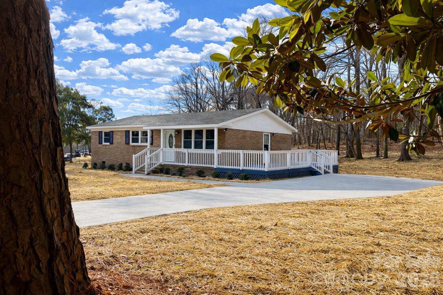 2201 Airdale Road Lancaster, SC 29720 - Photo 2 of 25 a view of pool with large trees and sky view