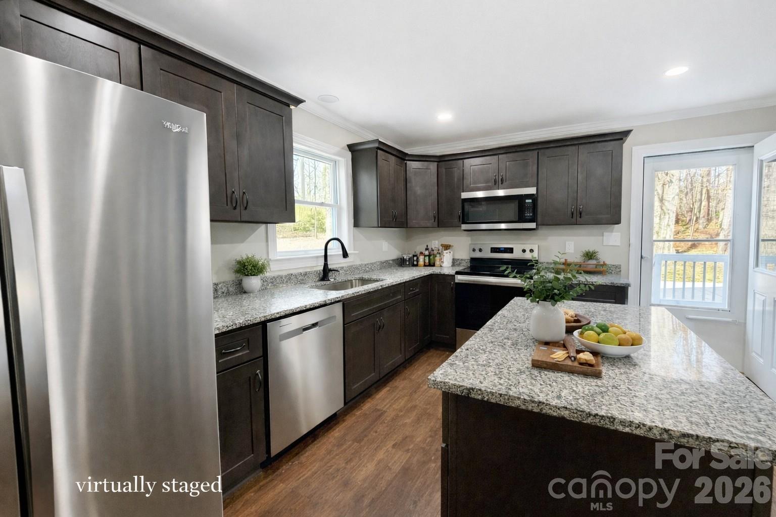2201 Airdale Road Lancaster, SC 29720 - Photo 8 of 25 a kitchen with granite countertop stainless steel appliances a sink stove refrigerator and a window