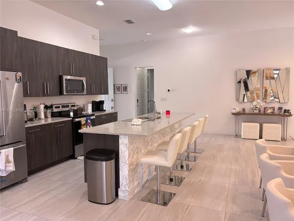 a kitchen with a sink and white cabinets