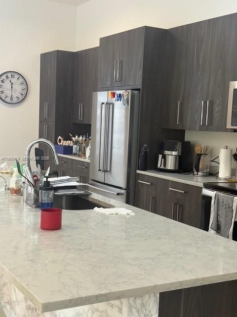 15062 Southwest 177th Terrace Miami, FL 33187 - Photo 14 of 41 a kitchen with a refrigerator and a sink
