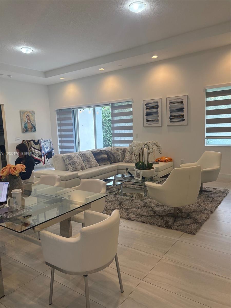 15062 Southwest 177th Terrace Miami, FL 33187 - Photo 16 of 41 a living room with a couch and a table with wooden floor