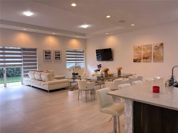 a bedroom with a large bed couch and a window