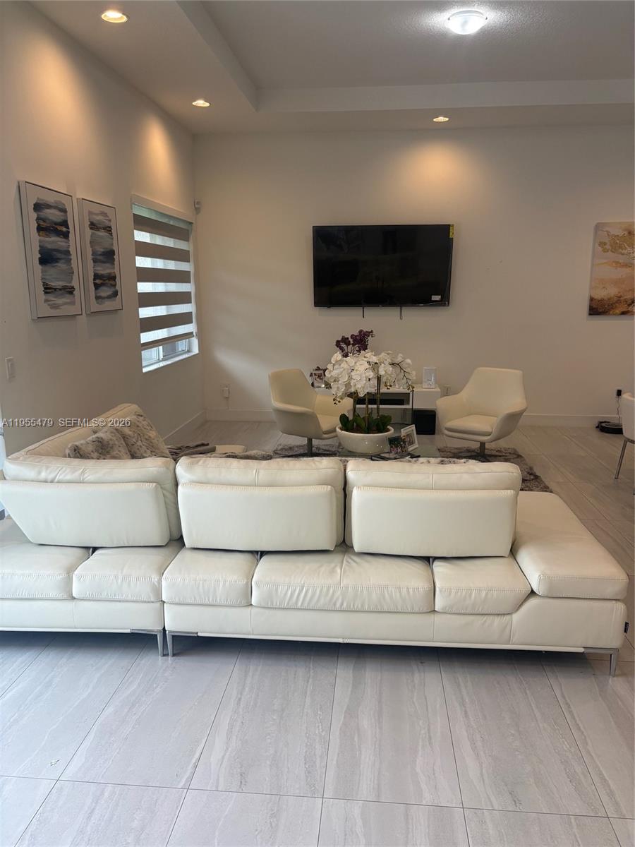 15062 Southwest 177th Terrace Miami, FL 33187 - Photo 18 of 41 a living room with furniture and a flat screen tv