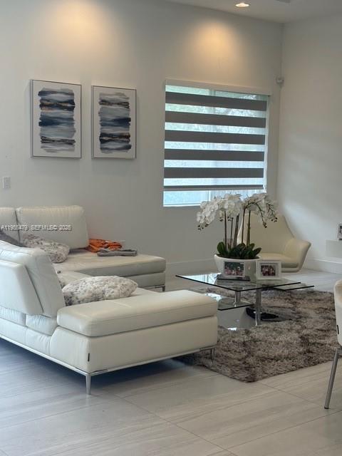 15062 Southwest 177th Terrace Miami, FL 33187 - Photo 19 of 41 a living room with furniture and window
