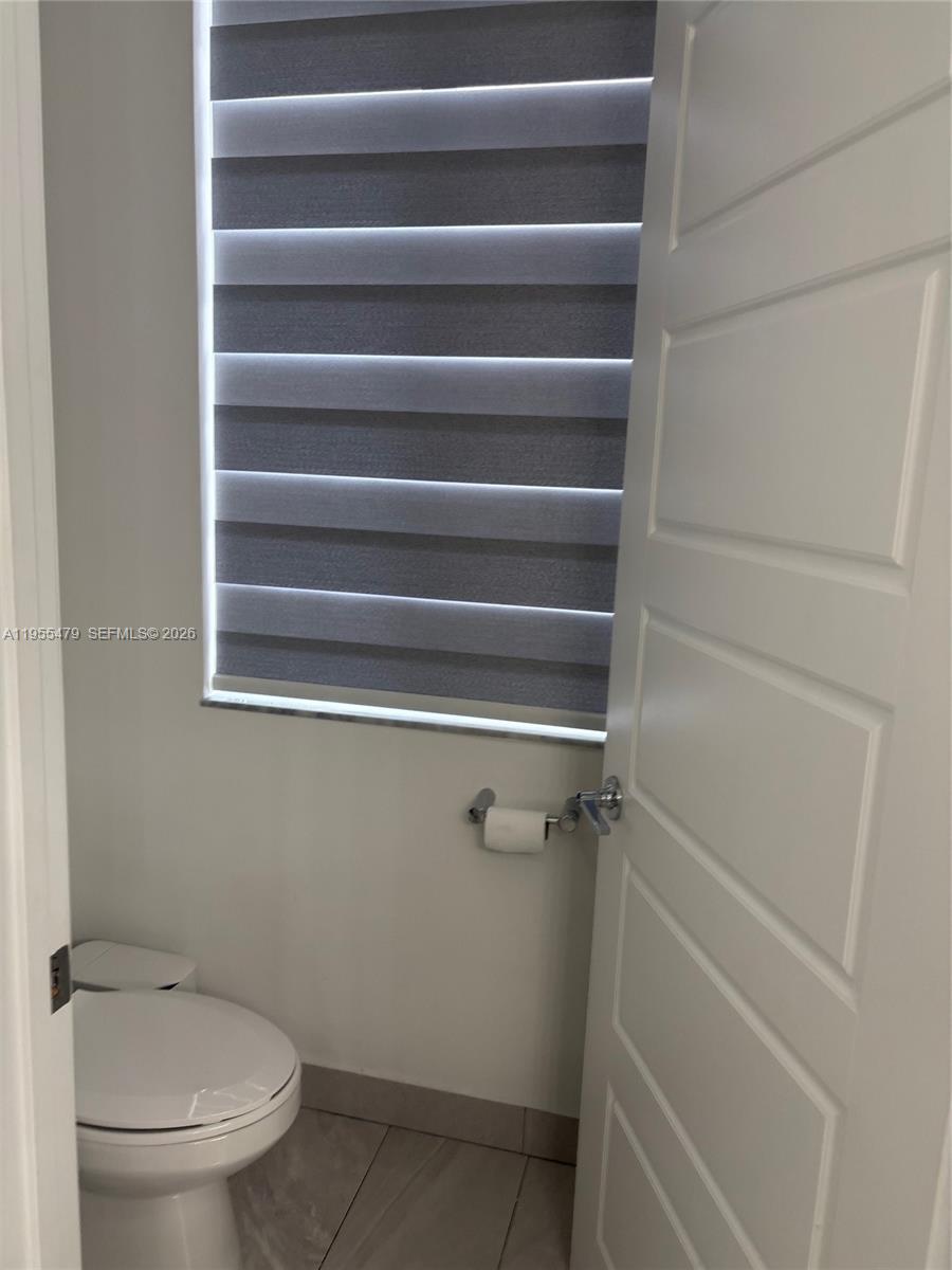 15062 Southwest 177th Terrace Miami, FL 33187 - Photo 21 of 41 a bathroom with a toilet and a shower