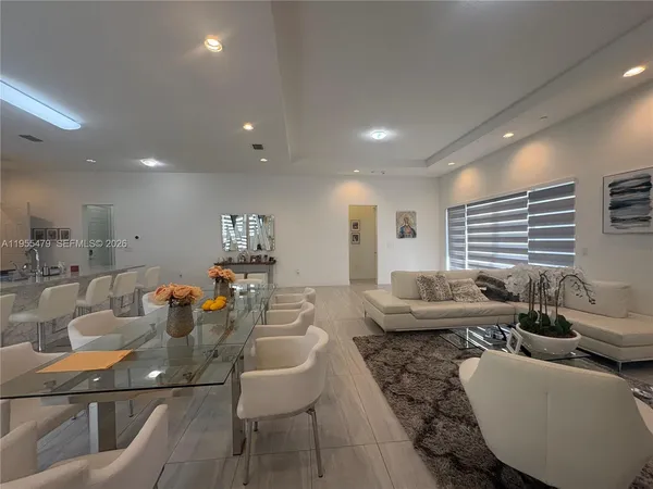 a bedroom with a bed and painting on the wall