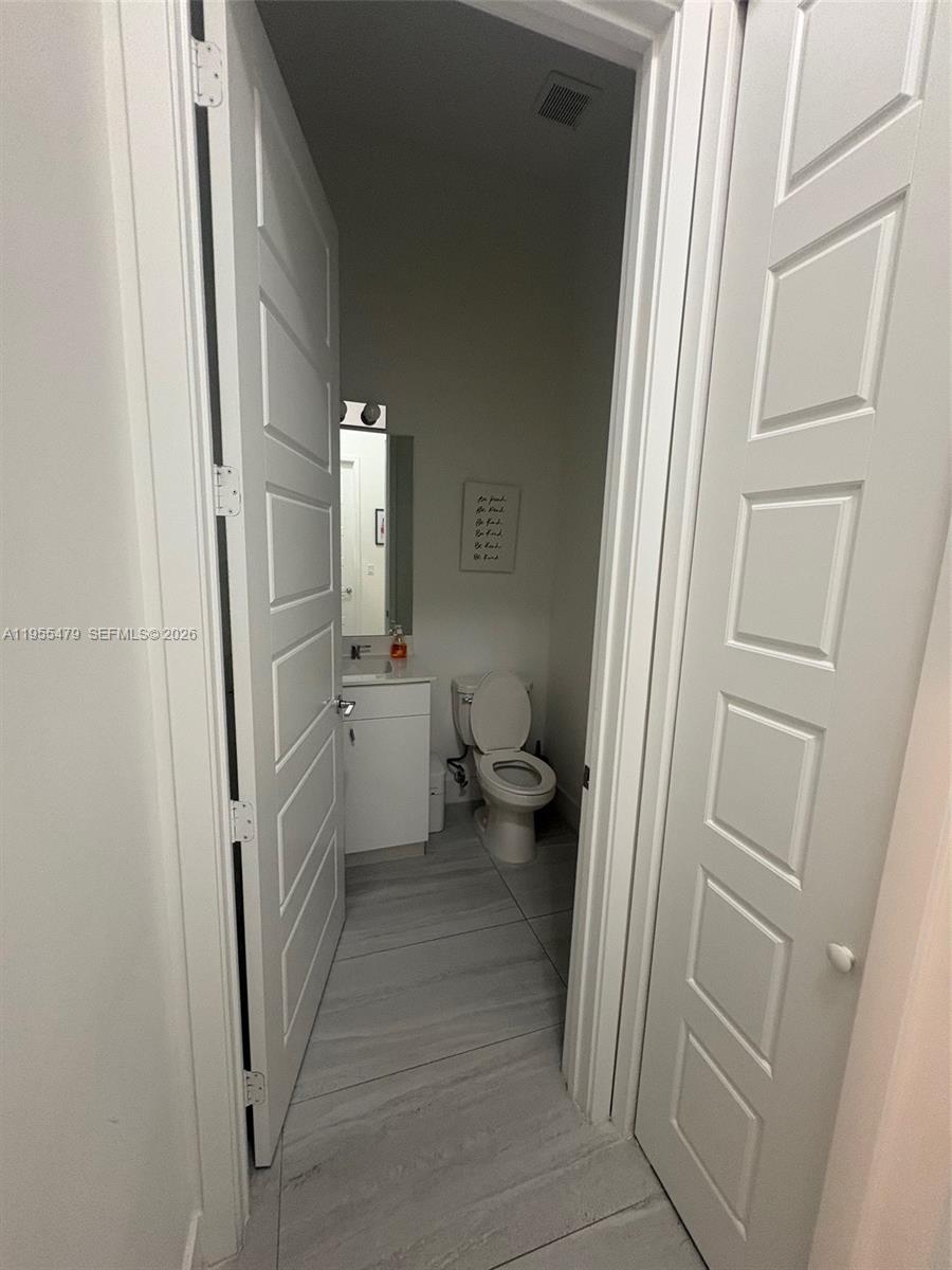 15062 Southwest 177th Terrace Miami, FL 33187 - Photo 22 of 41 a bathroom with a sink toilet and shower