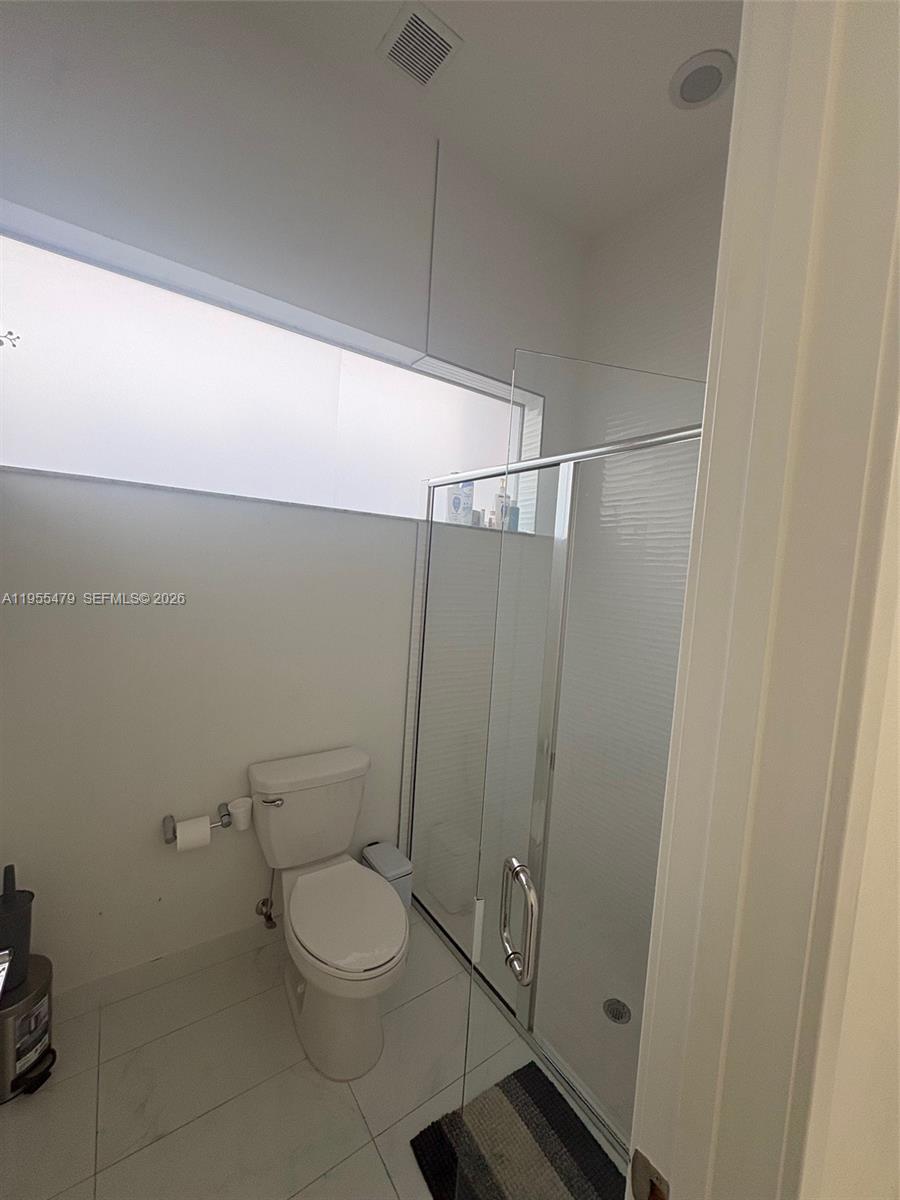 15062 Southwest 177th Terrace Miami, FL 33187 - Photo 26 of 41 a bathroom with a toilet and a shower