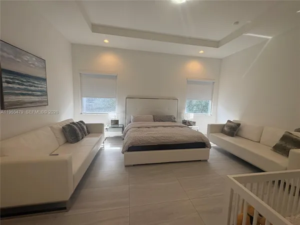 a bedroom with a bed and a large window