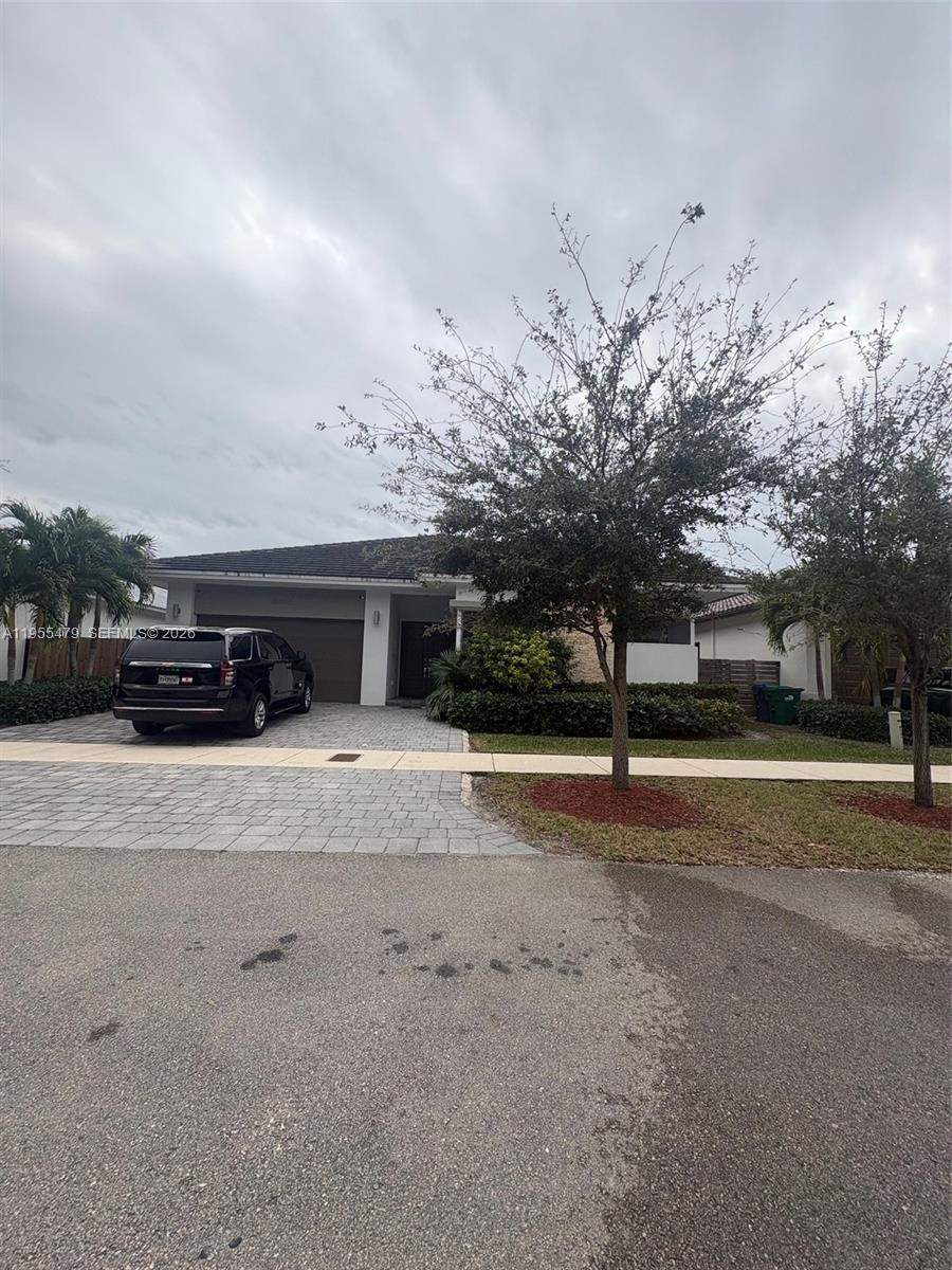 15062 Southwest 177th Terrace Miami, FL 33187 - Photo 4 of 41 a view of street with parked cars