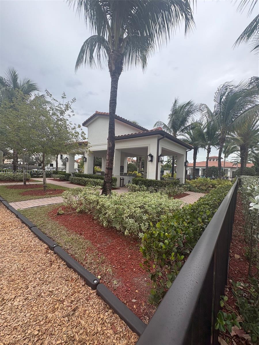 15062 Southwest 177th Terrace Miami, FL 33187 - Photo 7 of 41 a front view of a house with garden