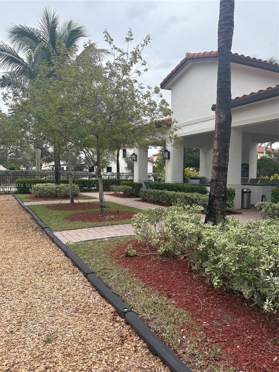 15062 Southwest 177th Terrace Miami, FL 33187 - Photo 9 of 41 a building with trees in front of it