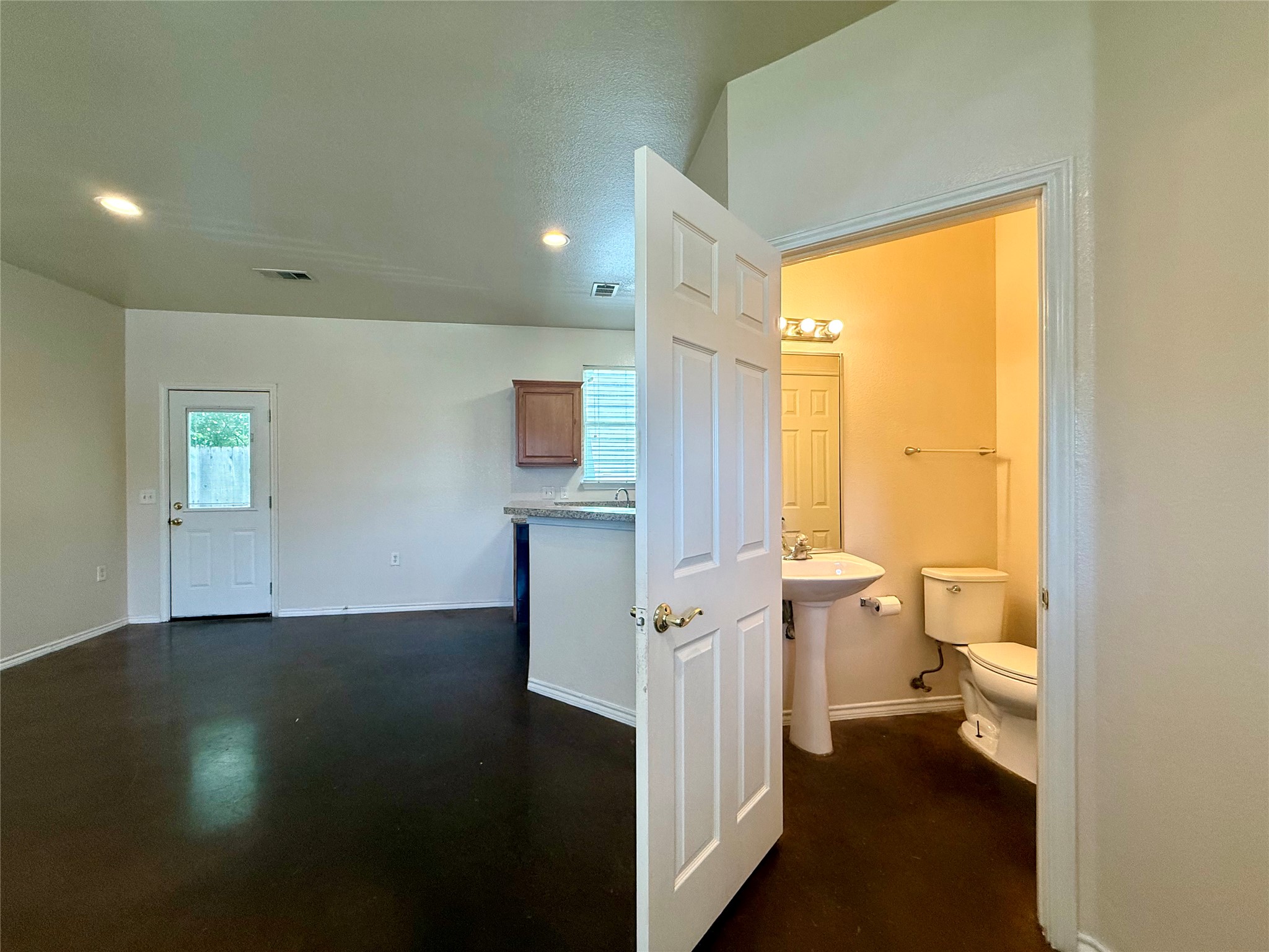 6912 Meador Avenue, Unit A Austin, TX 78752 - Photo 3 of 24 a view of a hallway view with wooden floor and a bathroom