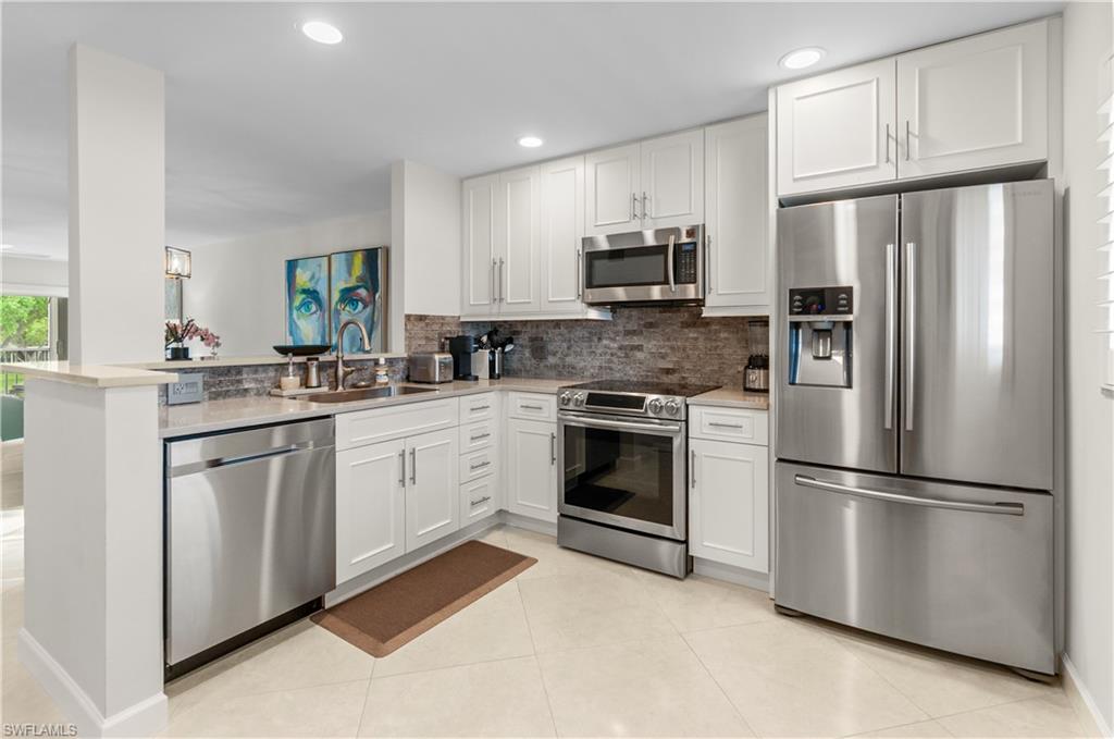 a kitchen with stainless steel appliances cabinets a sink and a window