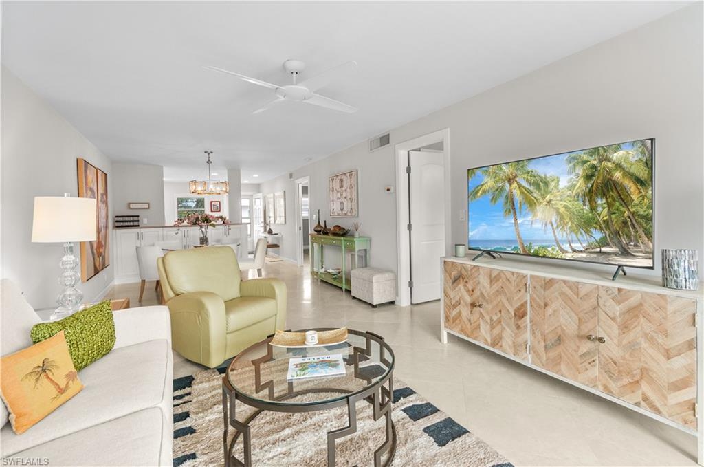 3150 Binnacle Drive, Unit 209 2J Naples, FL 34103 - Photo 11 of 32 a living room with furniture and a large window