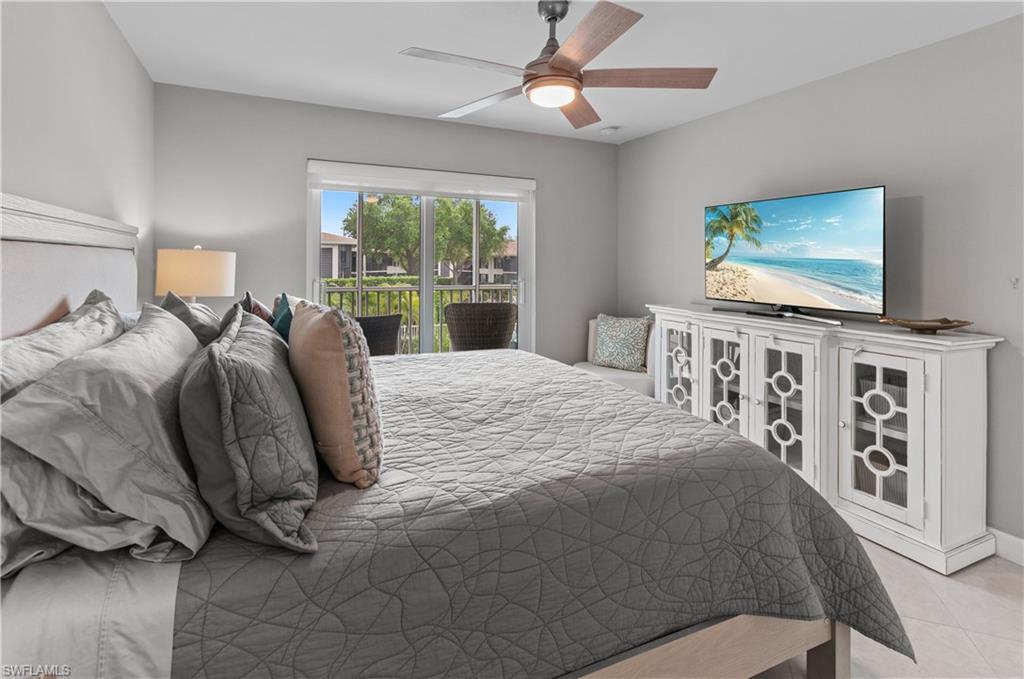 3150 Binnacle Drive, Unit 209 2J Naples, FL 34103 - Photo 14 of 32 a bed sitting in a bedroom next to a window