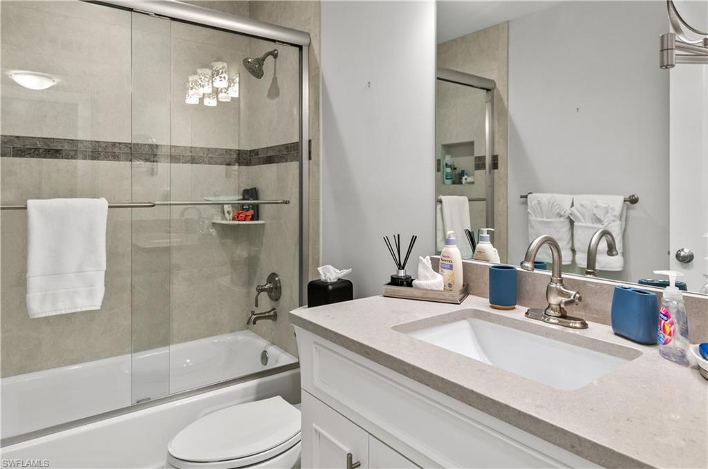 3150 Binnacle Drive, Unit 209 2J Naples, FL 34103 - Photo 17 of 32 a bathroom with a granite countertop sink toilet and shower