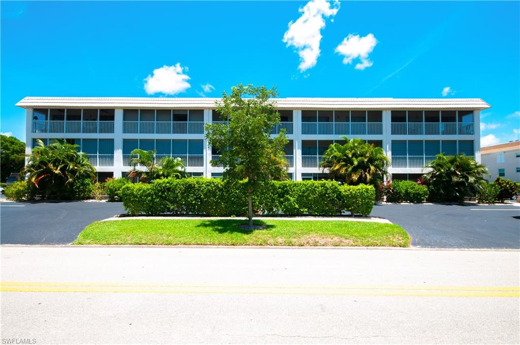 3150 Binnacle Drive, Unit 209 2J Naples, FL 34103 - Photo 22 of 32 a view of a building with a garden