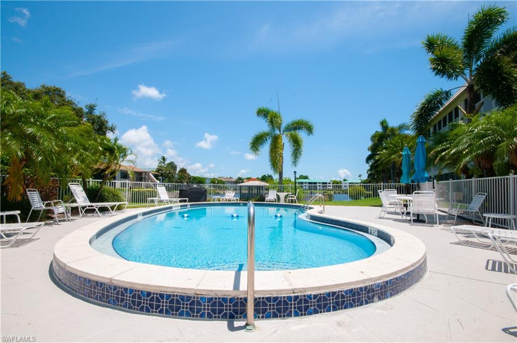 3150 Binnacle Drive, Unit 209 2J Naples, FL 34103 - Photo 26 of 32 a view of a swimming pool with a patio