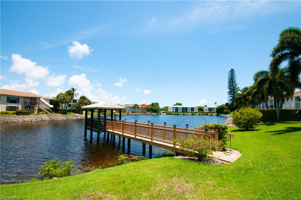 3150 Binnacle Drive, Unit 209 2J Naples, FL 34103 - Photo 27 of 32 a view of a lake with a house swimming pool and outdoor space