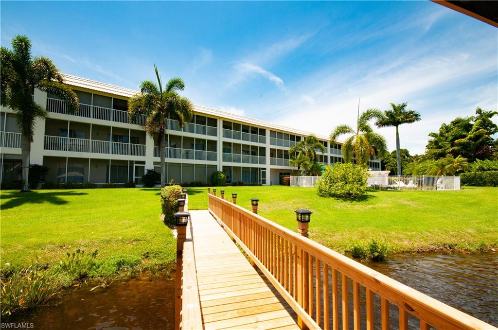 3150 Binnacle Drive, Unit 209 2J Naples, FL 34103 - Photo 30 of 32 a view of swimming pool with a garden and seating area