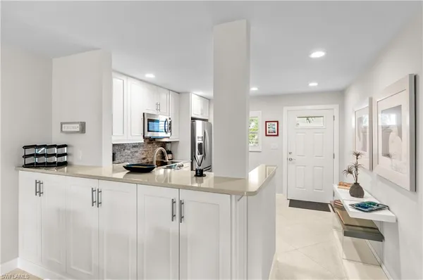 a kitchen with granite countertop a sink and cabinets