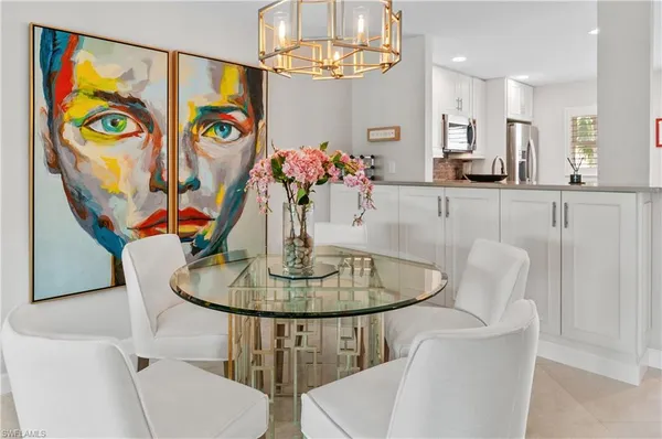 a dining room with furniture and chandelier