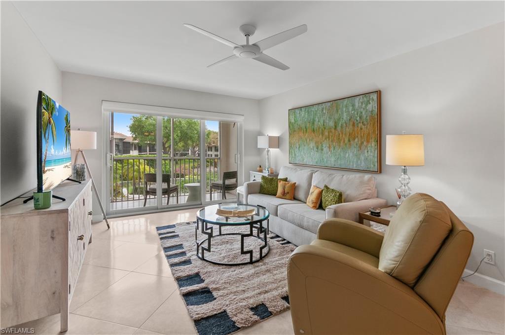 3150 Binnacle Drive, Unit 209 2J Naples, FL 34103 - Photo 9 of 32 a living room with furniture and a flat screen tv