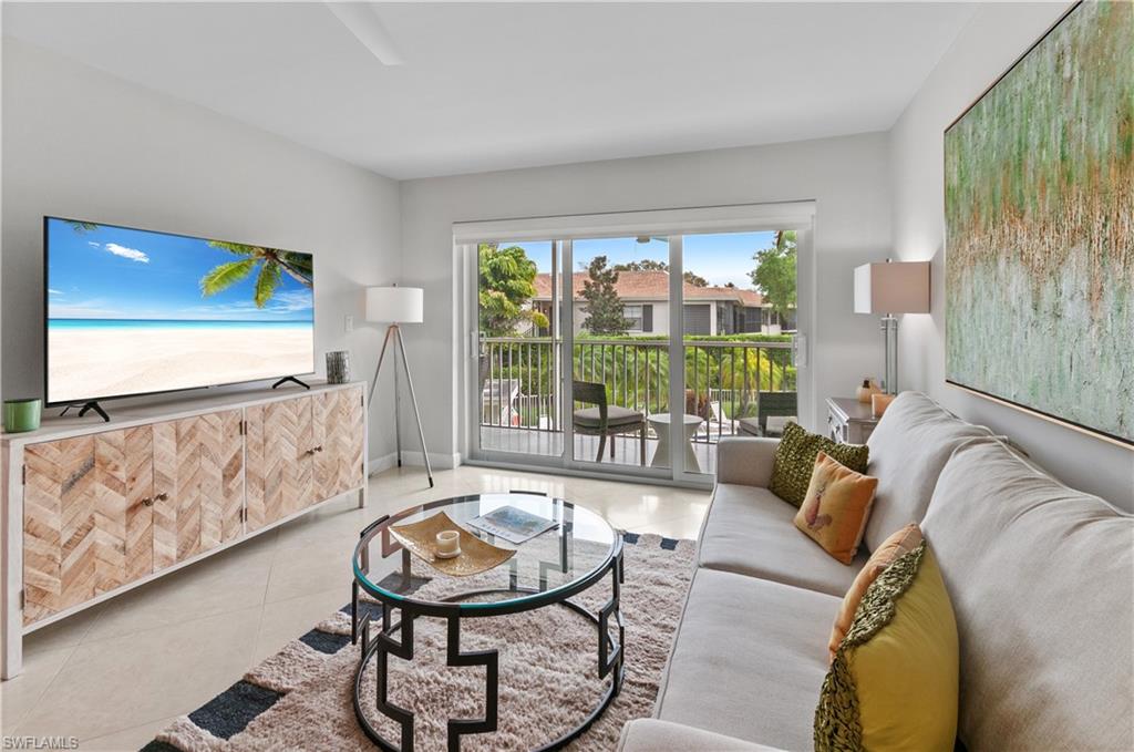 3150 Binnacle Drive, Unit 209 2J Naples, FL 34103 - Photo 10 of 32 a living room with furniture and a large window